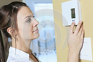 Woman set the thermostat at house