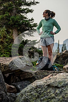 Woman Sets Backpack Down For A Break In Boulder Field