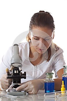 Woman setting with a microscope