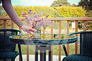 Woman setting table for tea outside