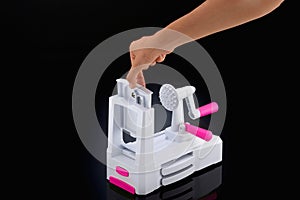 Woman setting up vegetable slicer