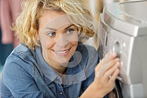 woman setting washing machine programme photo