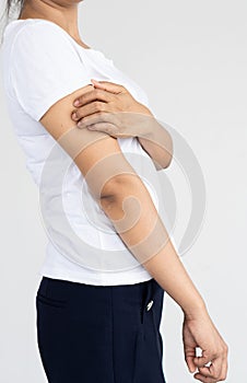 A woman with severe itching in her upper arm Arm pain and hand closed with white background medical concept.