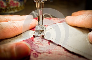 Woman at a sewing machine - two hands