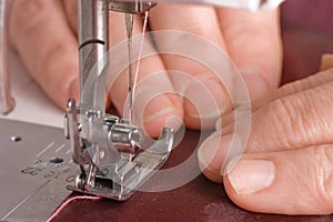 Woman sews on the sewing machine