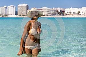 Woman in sexy bikini on the blue seagull beach of Cancun city in Riviera Maya of Mexico.