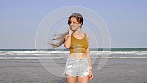 Woman in Sexy Dress with Long Hair Standing on the Seashore