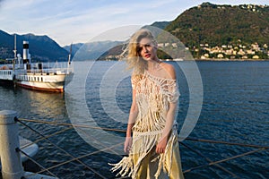 Woman sexy posing near Lake Como, Italy. Girl in a sexy dress near lake Como. Italian summer vacation. Fashion woman on