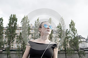 Woman in sexy vest in paris, france. Sensual woman wear sunglasses on cityscape. Wanderlust or vacation and travelling