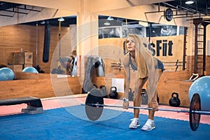 Woman shakes her back in gym