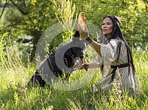 Woman shaman talking to a dog
