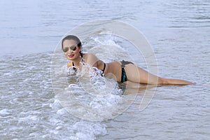 Woman shape with bikini enjoy wave on beach