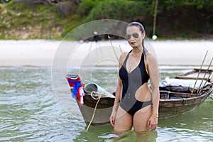 Woman shape sex symbol black bikini and boat on beach