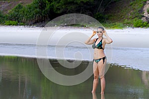 Woman shape symbol with pattern bikini on beach