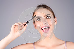 Woman shaping brown eyebrows. Woman eye with beautiful eyebrows. Shaped brows, long eyelashes. Paint eyebrows. Girl