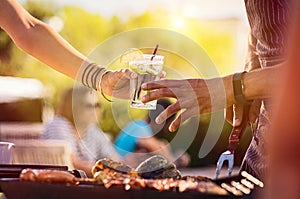 Woman sharing drink at bbq