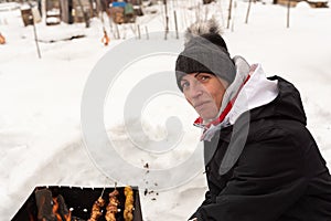 A woman with a shashlik on a shampoo, in winter