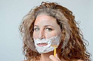 Woman shaving her beard