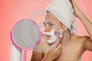 Woman shaving her face