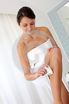 Woman shaving her legs