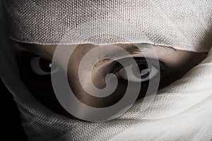 Woman with shawl on face photo