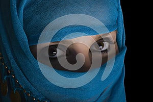 Woman with shawl on face photo