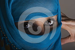 Woman with shawl on face