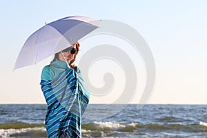 Woman and shawl at sea shore