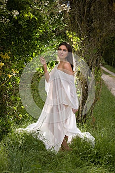Woman in sheer backlit dress like a fairy