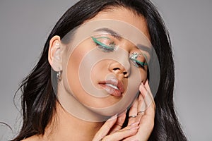 woman with shimmery green makeup and