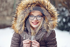Woman shiver outdoor at winter in glasses