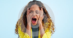 Woman in shock, portrait and screaming with fear in studio, expression or reaction isolated on blue background. Afraid