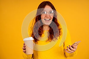 Woman with shocked expression on her face while using a mobile phone.