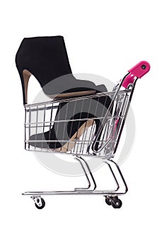 Woman shoes in shopping cart on white