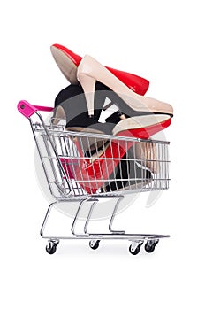 Woman shoes in shopping cart on white