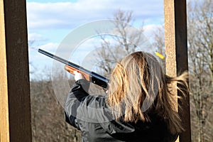 Woman shooting at trap shooting range