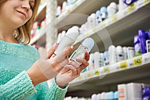 Woman in shop chooses deodorant