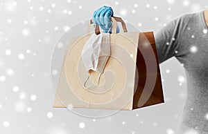 Woman with shopping bag, face mask and gloves