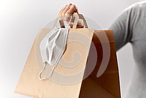 Woman with shopping bag and face protective mask