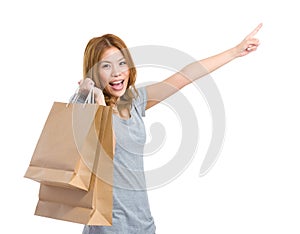 Woman with shopping bag and finger indicate direction