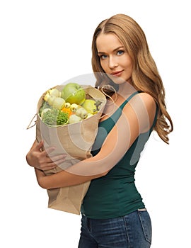 Woman with shopping bag full of fruits