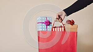 Woman with a shopping bag full of gifts