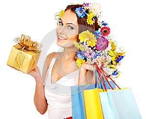 Woman with shopping bag holding flower.