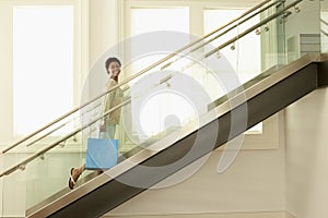 Woman With Shopping Bag On Modern Glass Stairs