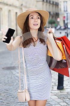 Woman with shopping bags calling for taxi cab