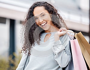 Woman, shopping bags or city retail fashion customer on street or road with Spain building background. Portrait, smile