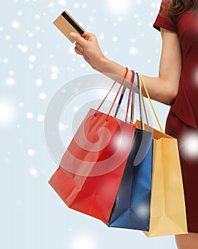 Woman with shopping bags and credit card