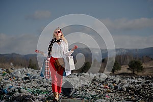 Woman with shopping bags on landfill, consumerism versus pollution concept.