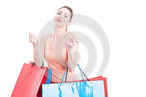 Woman with shopping bags making spending money gesture