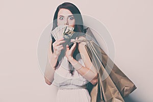 woman with shopping bags and money